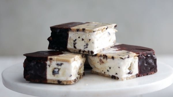 Chocolate dipped ice cream sandwiches with chocolate chip cookie dough